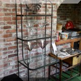 F74. Glass and metal bakers rack.